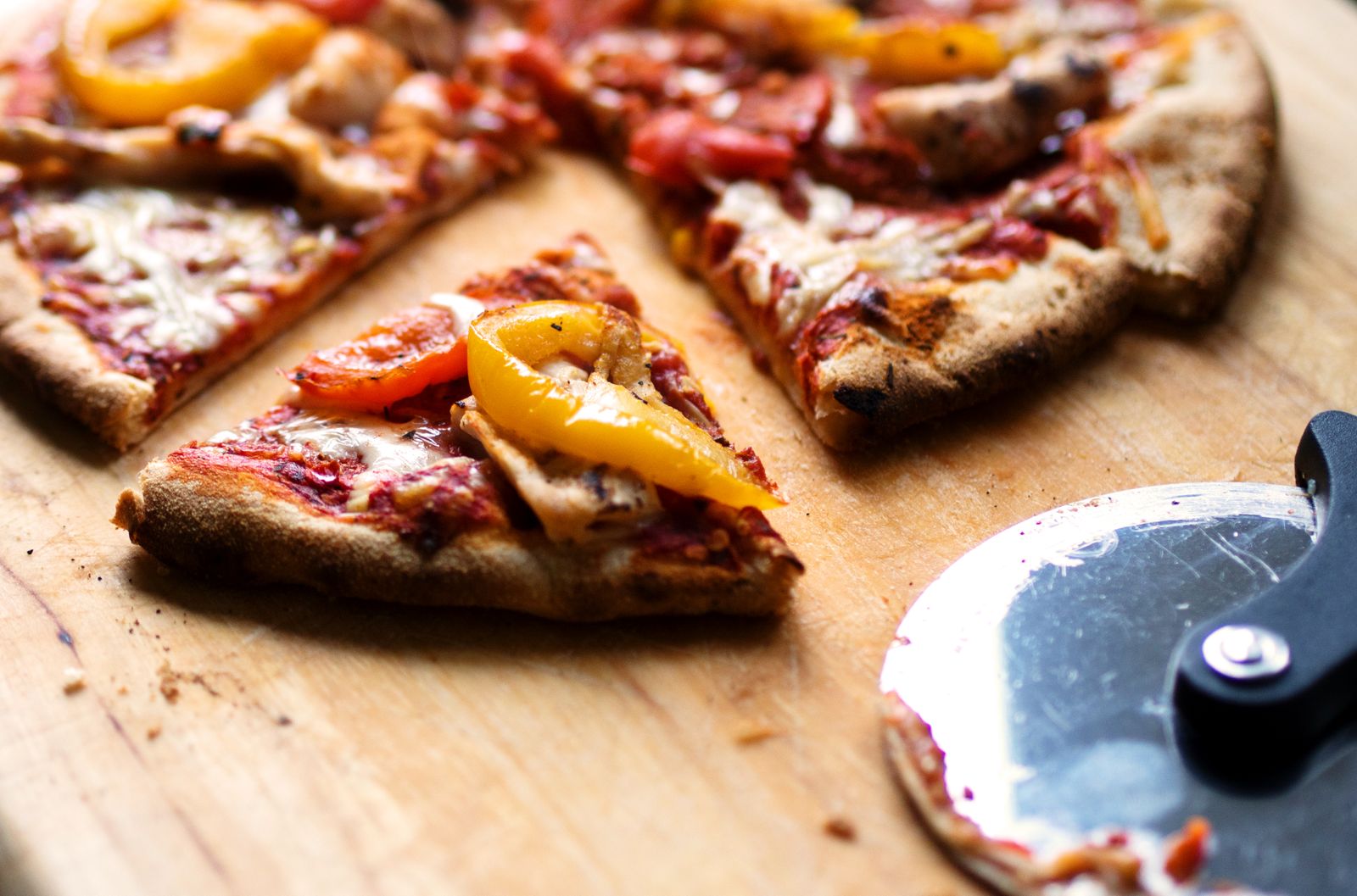 Fresh-baked signature pizza slice, blistered crust